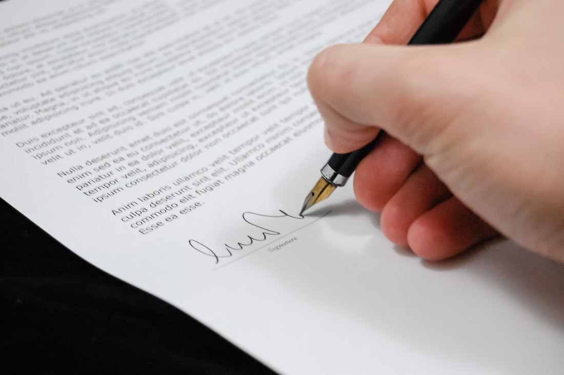 A person signing some document.